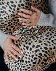 Person holding a leopard print silk pillowcase - 100% 6A Grade Mulberry silk