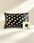 Black pillowcase with white airplane pattern next to a green box on a beige background - Lian Collection