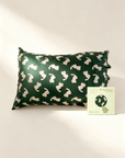 Green pillowcase with white animal pattern and a card on a light background - from Lian Collection