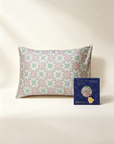 Floral-patterned pillowcase and a blue box with branding on a beige background - 100% 6A Grade Mulberry silk