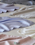 TENCEL™ Lyocell fabric swatches in various colors with Tencel logo.