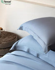 Blue bedding set with pillows on a bed, TENCEL™ Lyocell