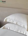 White pillows on a bed with Tencel logo in the corner - TENCEL™ Lyocell