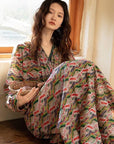 Model wearing an elegant bamboo cotton robe with oriental patterns, featuring a relaxed fit and a green sash, perfect for loungewear and home comfort